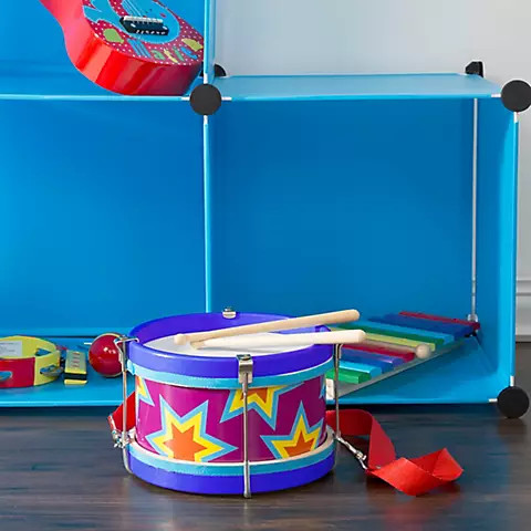 Toy drum with neck strap outlet